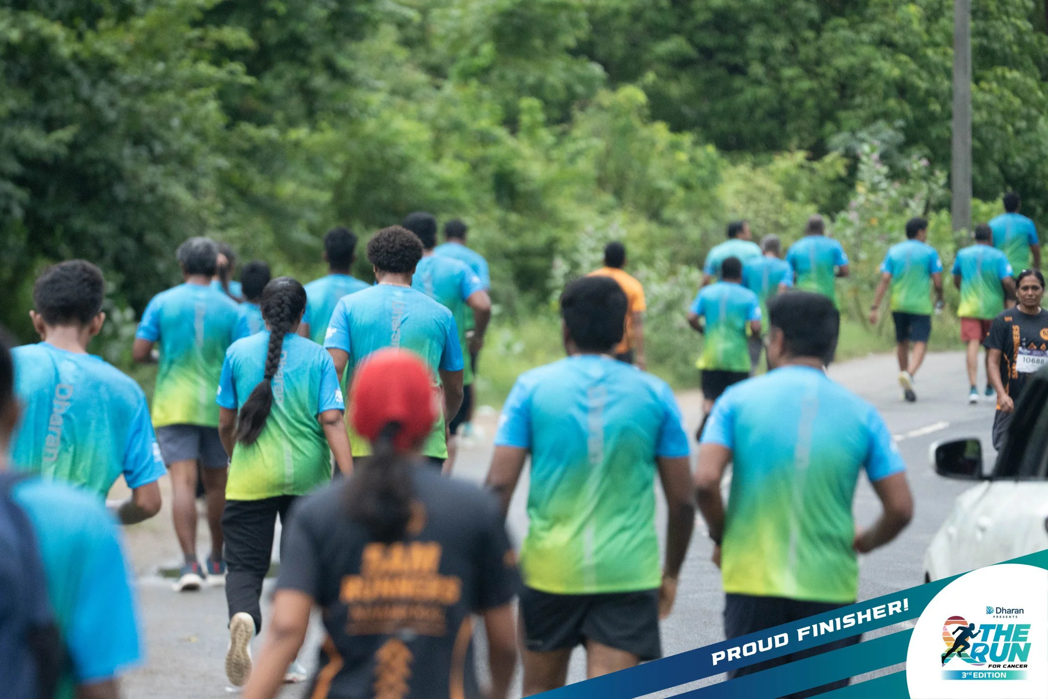 Runners in blue and green jerseys fill the tree-lined 2026 route.