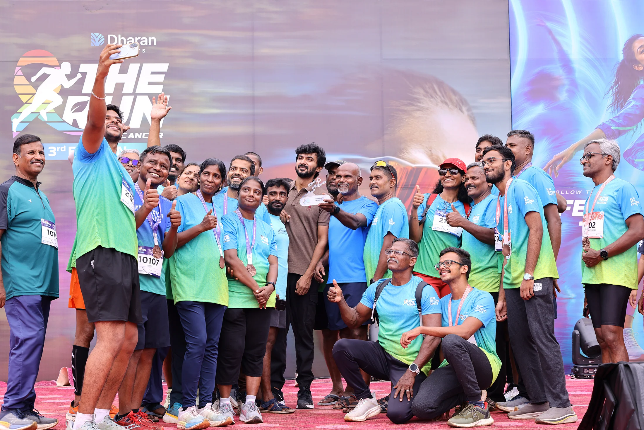 Runners and organisers celebrating on the 2026 stage.