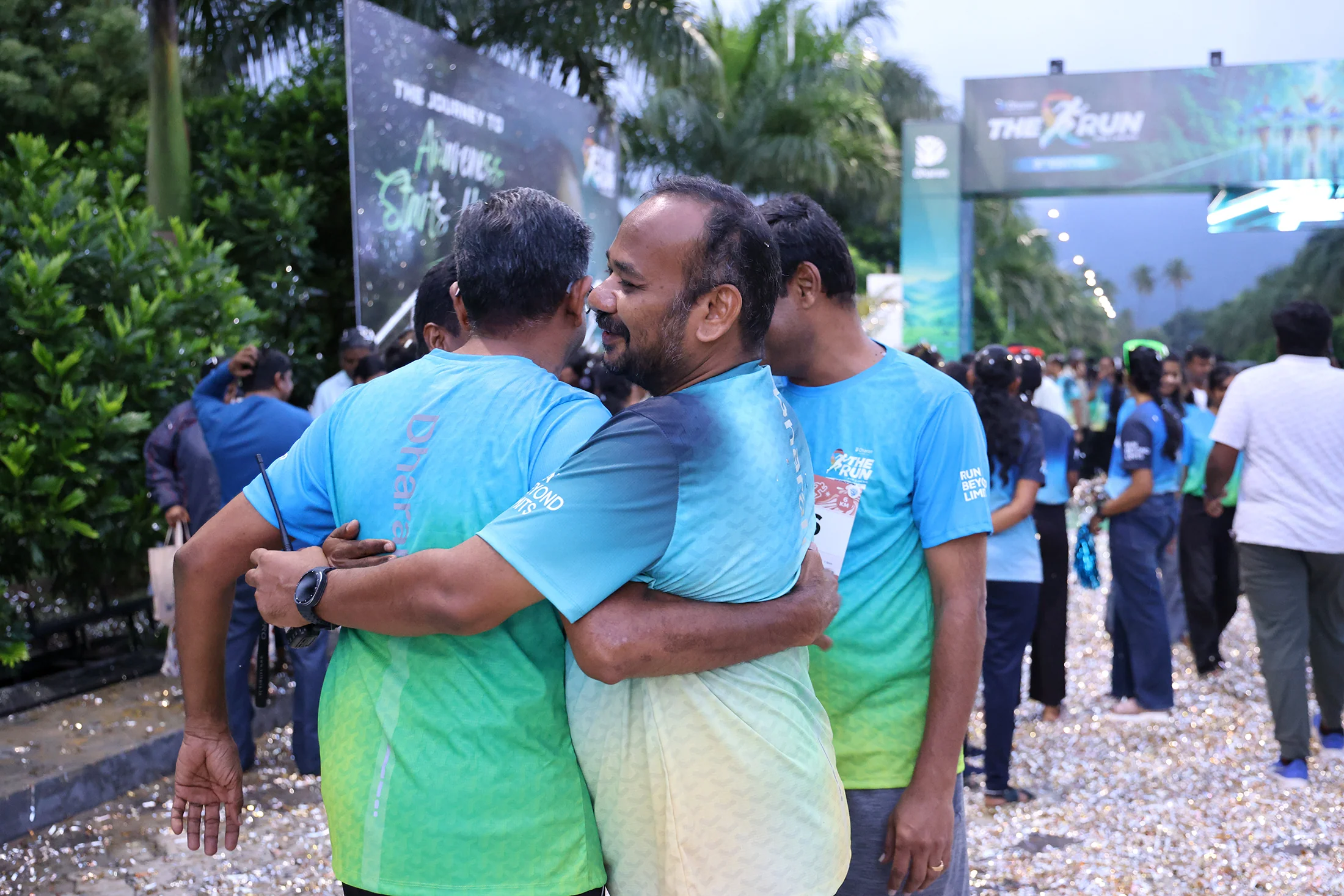 Two runners embracing near the 2026 finish area.