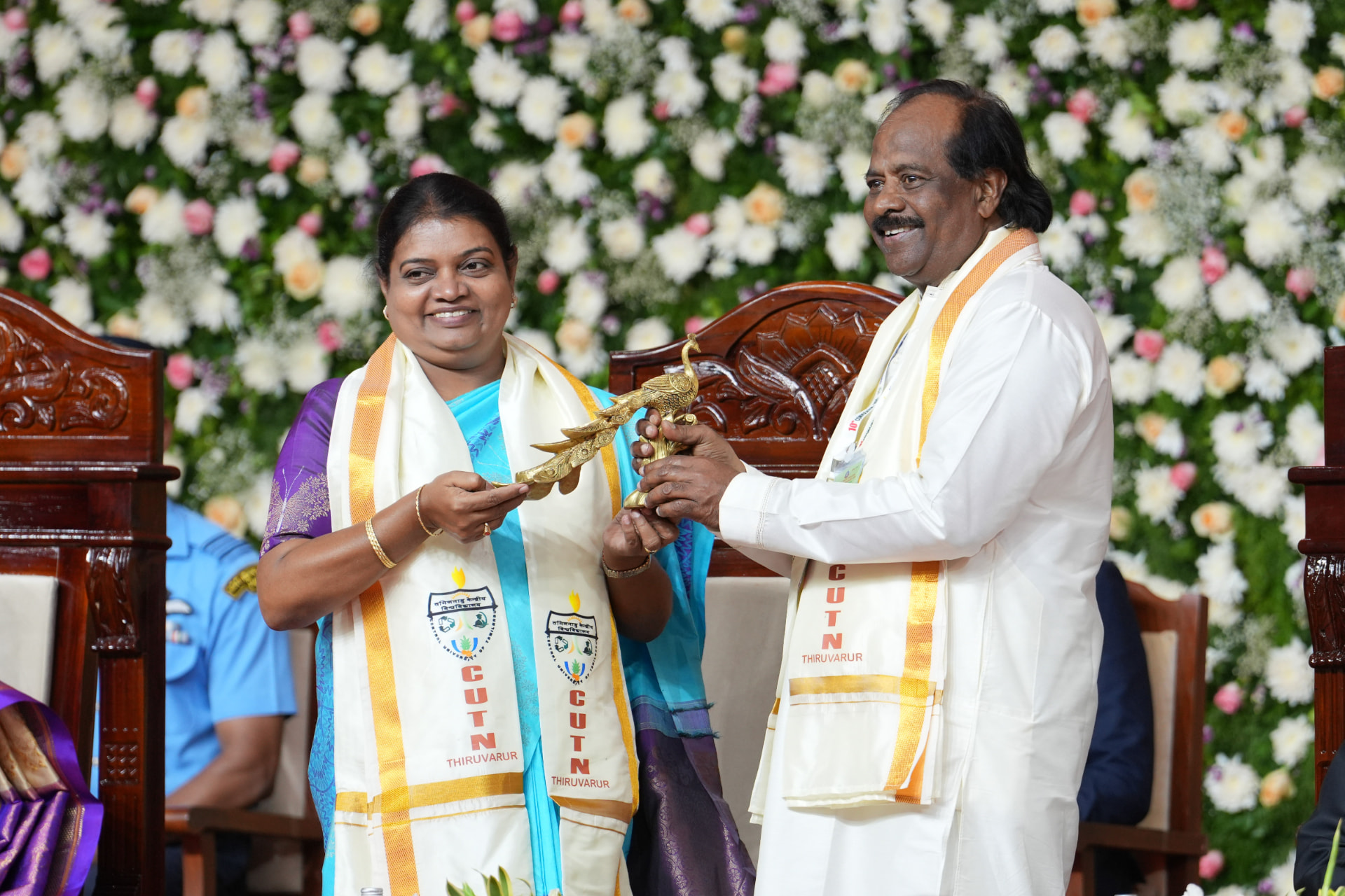 A brass peacock, presented on stage