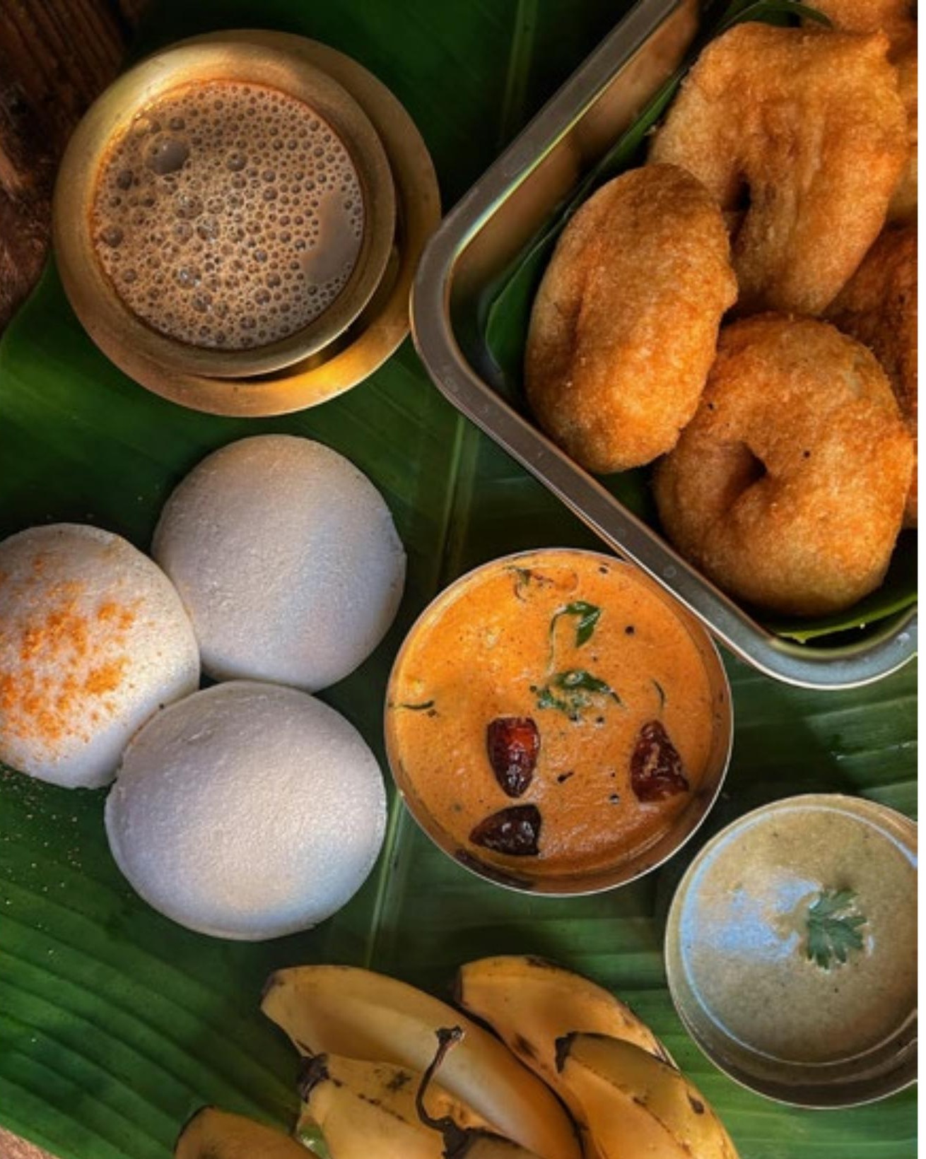 Idli, vada, sambar — on a banana leaf, the way it's meant to be eaten