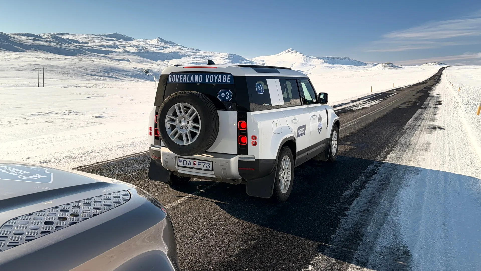 Branded Roverland Voyage Land Rover Defender on a snowy Icelandic highway